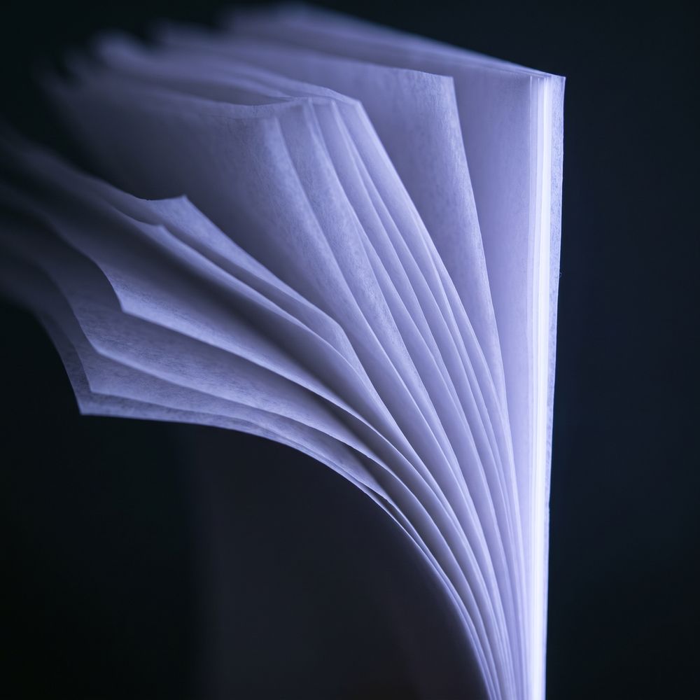 Layered translucent sheets converging toward a single lit edge